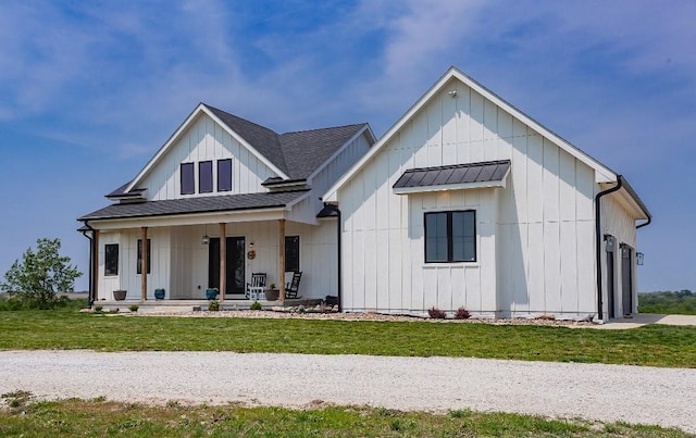 1103 170th St, Dexter, IA 50070 - modern farmhouse with covered porch, board and batten siding, a standing seam roof, and a front yard
