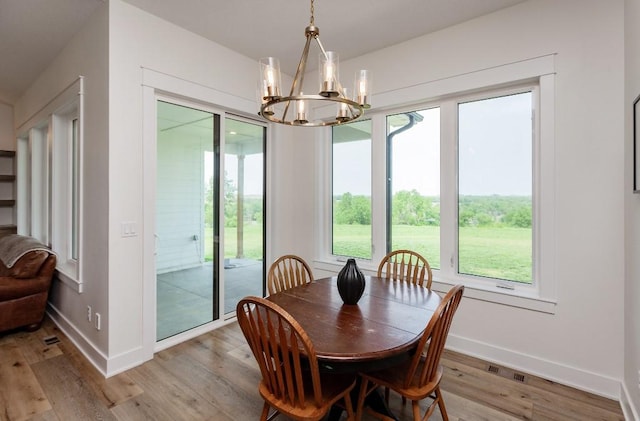 1103 170th St, Dexter, IA 50070 - dining room with a chandelier, plenty of natural light, and light wood-style flooring
