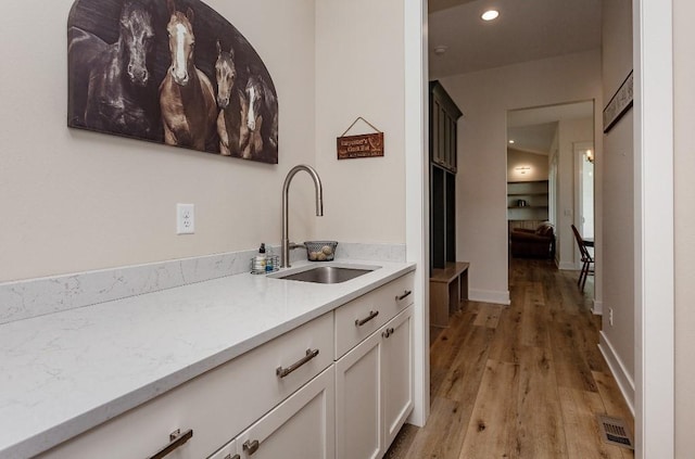 1103 170th St, Dexter, IA 50070 - kitchen with light wood finished floors, white cabinetry, and recessed lighting