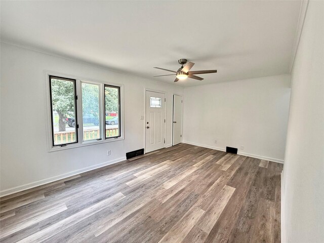 2000 E 21st St, Des Moines, IA 50317 - unfurnished living room featuring ceiling fan and dark wood-style floors