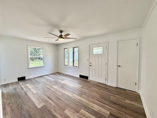 2000 E 21st St, Des Moines, IA 50317 - entrance foyer featuring ceiling fan, wood finished floors, and crown molding