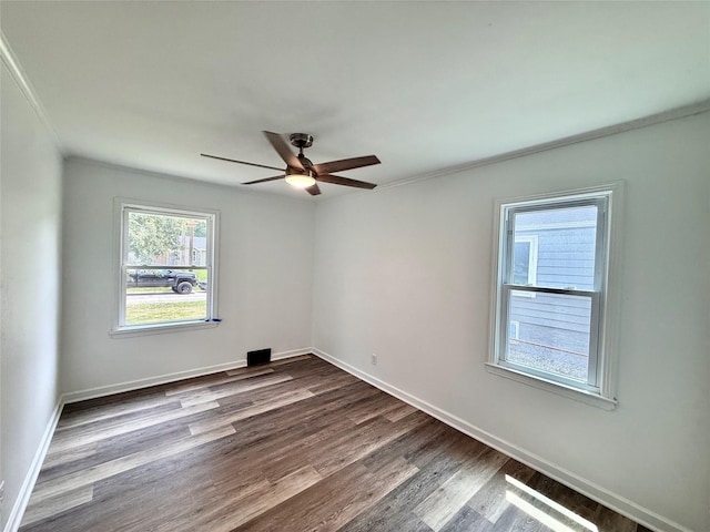 2000 E 21st St, Des Moines, IA 50317 - empty room with ornamental molding, dark wood finished floors, and a ceiling fan