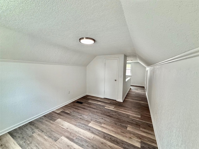 2000 E 21st St, Des Moines, IA 50317 - additional living space featuring a textured ceiling, wood finished floors, lofted ceiling, and a textured wall