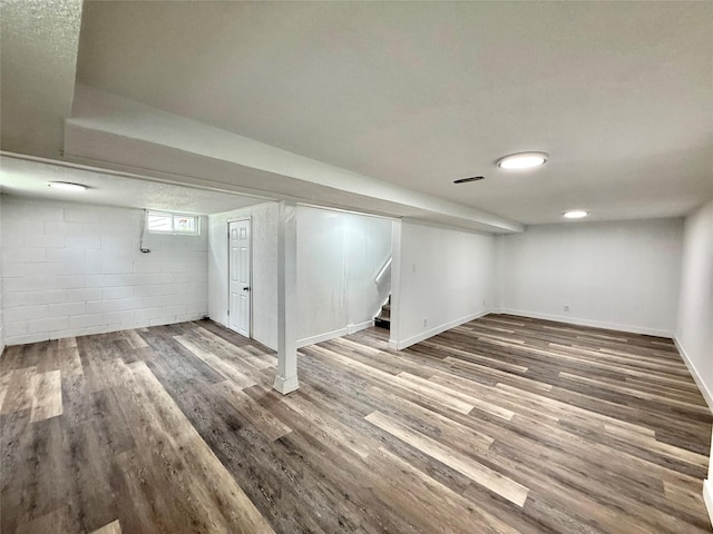 2000 E 21st St, Des Moines, IA 50317 - below grade area featuring stairs, wood finished floors, and concrete block wall