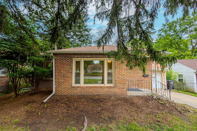4008 Douglas Ave, Des Moines, IA 50310 - view of front facade with a garage, brick siding, and concrete driveway