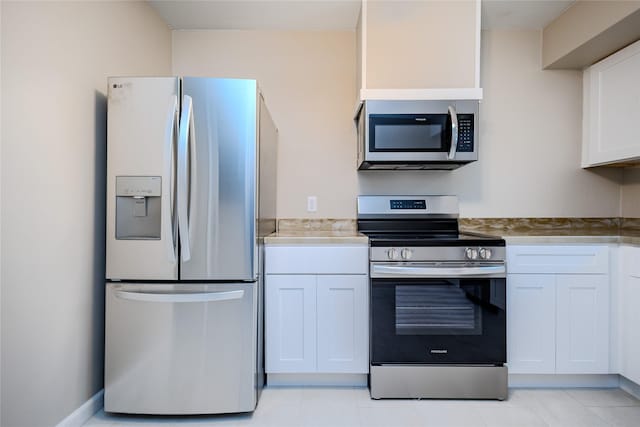 4008 Douglas Ave, Des Moines, IA 50310 - kitchen featuring appliances with stainless steel finishes, white cabinets, light tile patterned flooring, and light countertops