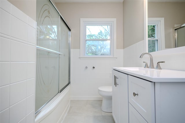 4008 Douglas Ave, Des Moines, IA 50310 - bathroom with tile walls, vanity, tile patterned flooring, shower / bath combination with glass door, and a wainscoted wall