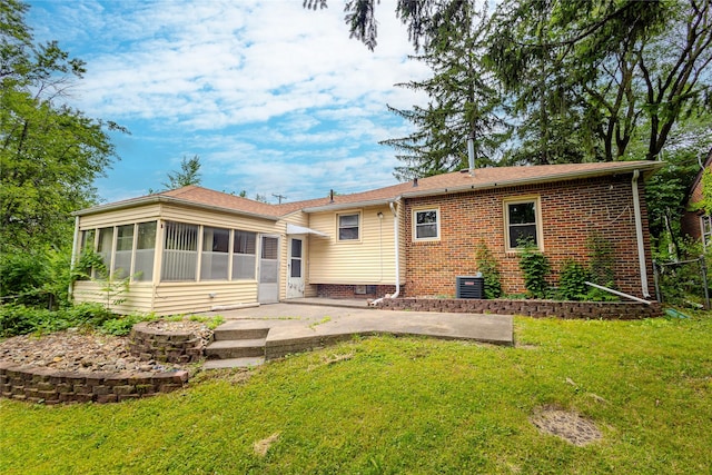 4008 Douglas Ave, Des Moines, IA 50310 - back of property featuring a sunroom, a patio area, a yard, and brick siding