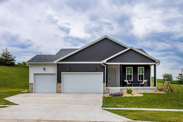 1302 S L Ct, Indianola, IA 50125 - view of front of house featuring a garage, driveway, a front lawn, a porch, and roof with shingles