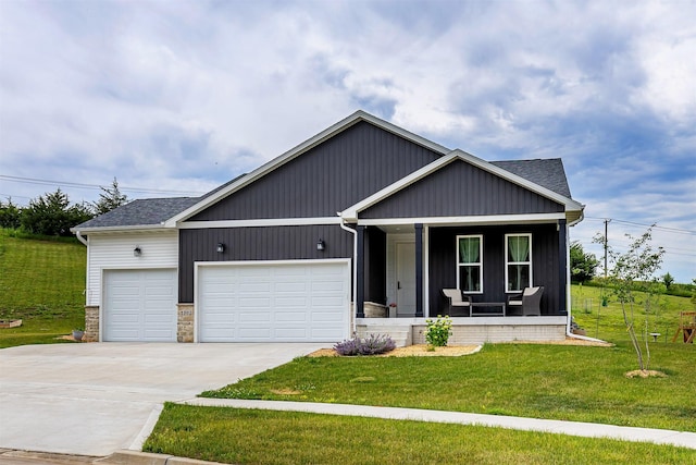 1302 S L Ct, Indianola, IA 50125 - view of front of home featuring a porch, a garage, concrete driveway, a front yard, and roof with shingles