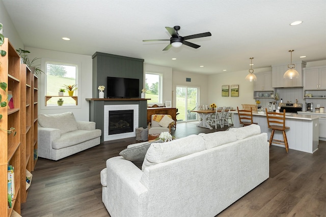 1302 S L Ct, Indianola, IA 50125 - living room featuring a fireplace, ceiling fan, dark wood-style floors, and recessed lighting