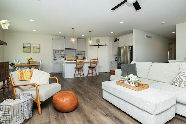 1302 S L Ct, Indianola, IA 50125 - living room with recessed lighting, ceiling fan, dark wood-style floors, and a barn door