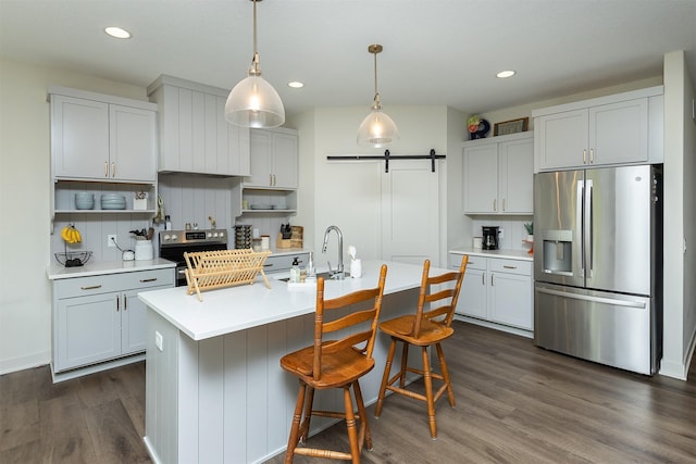 1302 S L Ct, Indianola, IA 50125 - kitchen featuring stainless steel appliances, open shelves, light countertops, dark wood-style floors, and a barn door