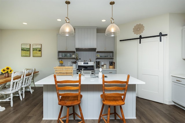 1302 S L Ct, Indianola, IA 50125 - kitchen featuring electric stove, a barn door, dark wood-style floors, a center island with sink, and recessed lighting
