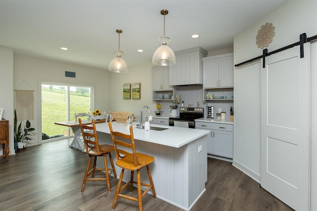 1302 S L Ct, Indianola, IA 50125 - kitchen with stainless steel electric stove, open shelves, light countertops, dark wood-style flooring, and recessed lighting