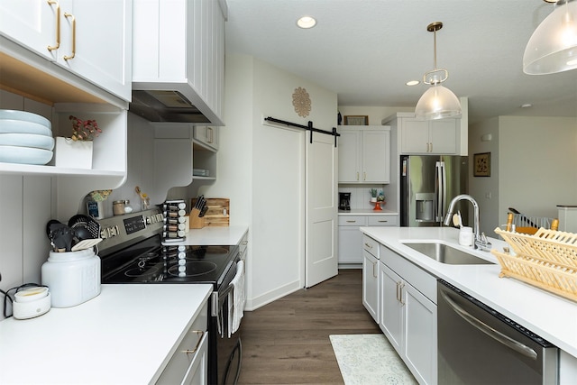 1302 S L Ct, Indianola, IA 50125 - kitchen with stainless steel appliances, a barn door, dark wood-style floors, light countertops, and recessed lighting