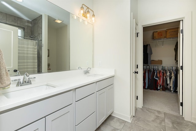 1302 S L Ct, Indianola, IA 50125 - bathroom with double vanity, a spacious closet, curtained shower, and tile patterned flooring