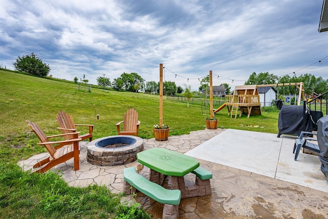 1302 S L Ct, Indianola, IA 50125 - view of patio with a playground and an outdoor fire pit