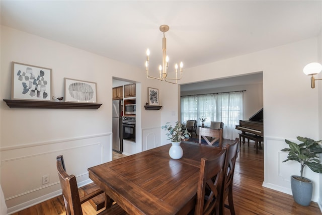 912 23rd St, West Des Moines, IA 50265 - dining room with a chandelier, light wood-style flooring, and a wainscoted wall