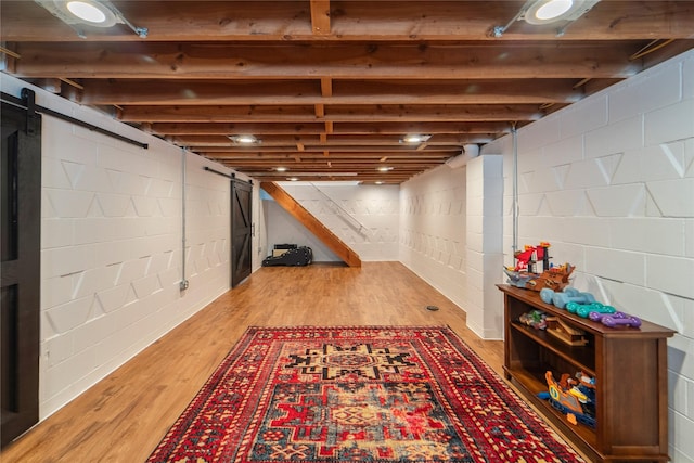 912 23rd St, West Des Moines, IA 50265 - finished below grade area featuring a barn door and wood finished floors