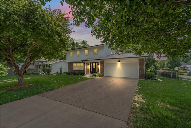 912 23rd St, West Des Moines, IA 50265 - traditional home featuring an attached garage, brick siding, and driveway