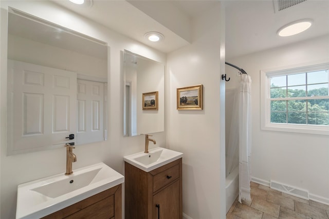912 23rd St, West Des Moines, IA 50265 - bathroom featuring two vanities and shower / bath combo with shower curtain
