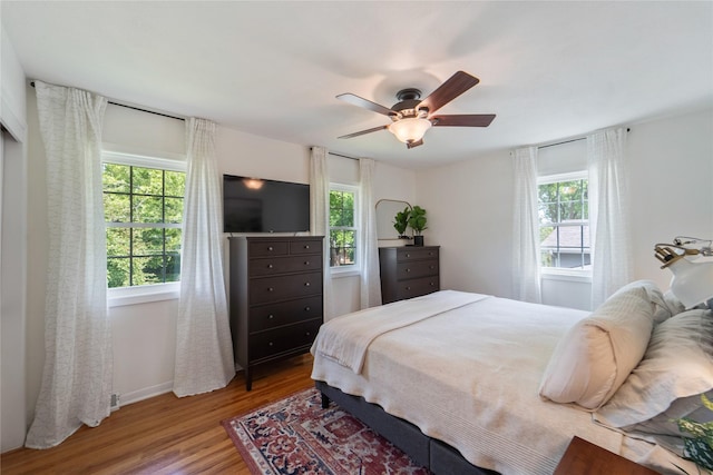912 23rd St, West Des Moines, IA 50265 - bedroom with multiple windows, wood finished floors, and a ceiling fan