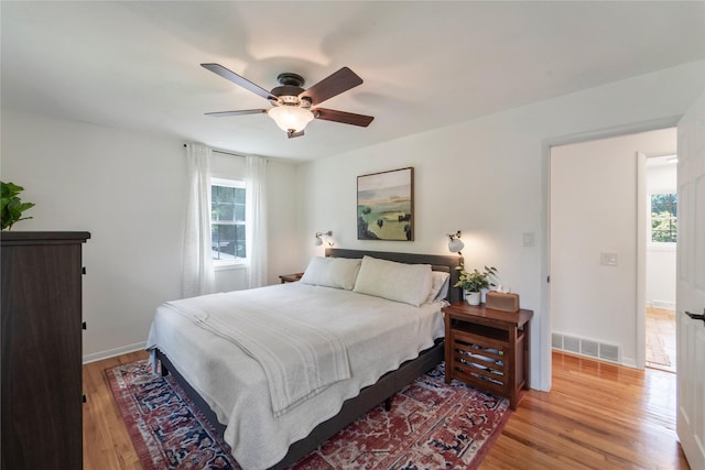 912 23rd St, West Des Moines, IA 50265 - bedroom featuring light wood finished floors, multiple windows, and a ceiling fan