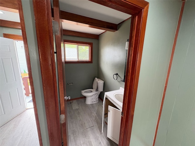 3206 62nd St, Des Moines, IA 50322 - half bath featuring vanity, beam ceiling, and wood finished floors