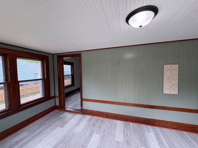 3206 62nd St, Des Moines, IA 50322 - empty room featuring light wood-style flooring and wooden walls