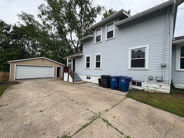 3206 62nd St, Des Moines, IA 50322 - rear view of property featuring a detached garage and an outbuilding