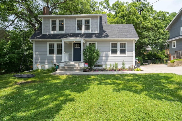 5617 Grand Ave, Des Moines, IA 50312 - view of front of home with a front lawn, a chimney, and a shingled roof