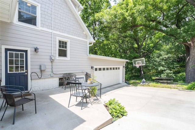 5617 Grand Ave, Des Moines, IA 50312 - view of patio / terrace with driveway and an attached garage