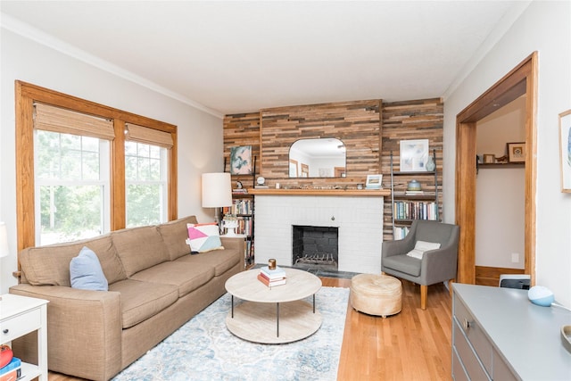 5617 Grand Ave, Des Moines, IA 50312 - living area featuring wooden walls, light wood-style floors, a fireplace, and ornamental molding