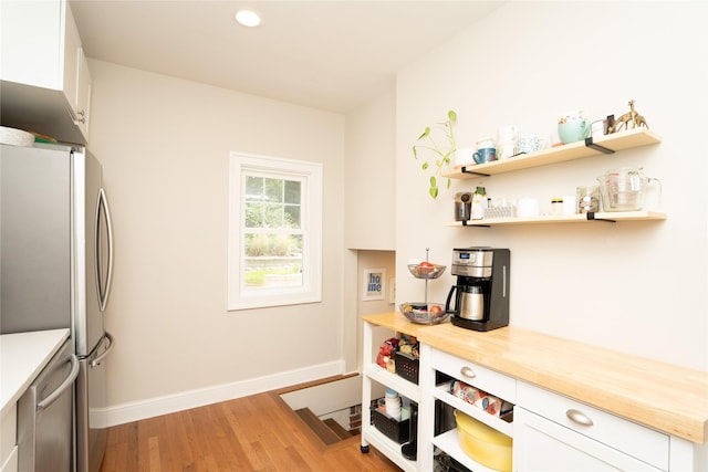 5617 Grand Ave, Des Moines, IA 50312 - kitchen featuring stainless steel appliances, light wood-style floors, white cabinetry, open shelves, and recessed lighting