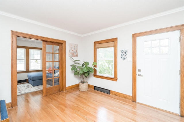 5617 Grand Ave, Des Moines, IA 50312 - entryway with light wood-style flooring and ornamental molding