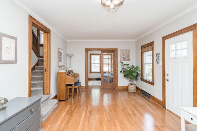 5617 Grand Ave, Des Moines, IA 50312 - foyer entrance featuring light wood-type flooring, stairs, and ornamental molding