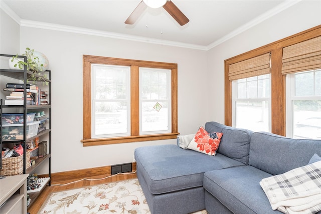 5617 Grand Ave, Des Moines, IA 50312 - living area with wood finished floors, ornamental molding, and ceiling fan
