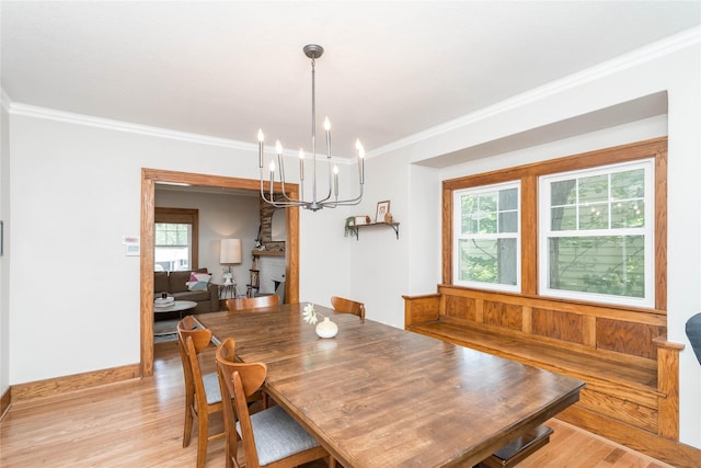 5617 Grand Ave, Des Moines, IA 50312 - dining room with a chandelier, light wood-style floors, and crown molding