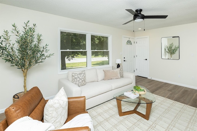 401 NE Harvey St, Grimes, IA 50111 - living area featuring wood finished floors, a ceiling fan, and a textured ceiling