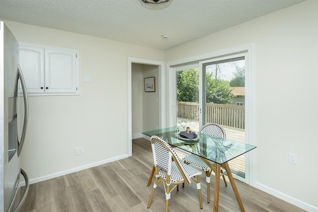 401 NE Harvey St, Grimes, IA 50111 - dining room with light wood-style floors and a textured ceiling