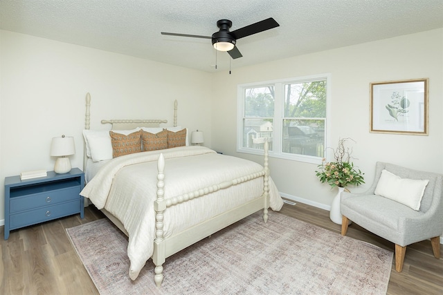 401 NE Harvey St, Grimes, IA 50111 - bedroom featuring wood finished floors, ceiling fan, and a textured ceiling