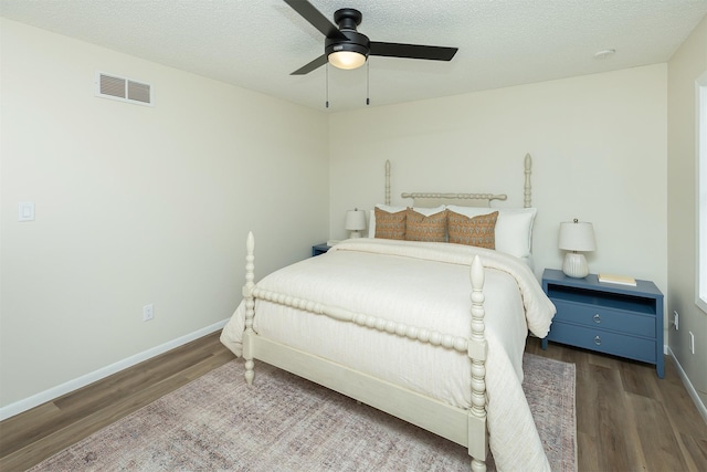 401 NE Harvey St, Grimes, IA 50111 - bedroom featuring wood finished floors, a ceiling fan, and a textured ceiling