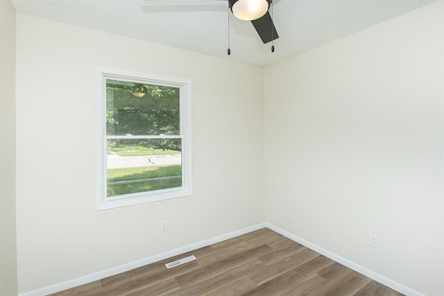 401 NE Harvey St, Grimes, IA 50111 - spare room featuring wood finished floors and a ceiling fan