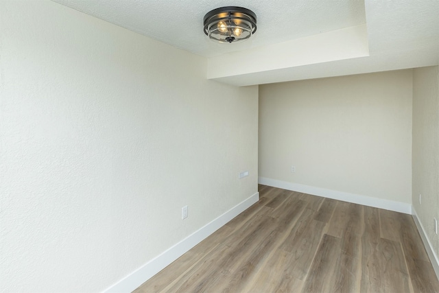 401 NE Harvey St, Grimes, IA 50111 - unfurnished room featuring wood finished floors and a textured ceiling