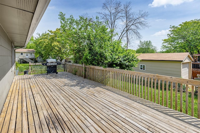 401 NE Harvey St, Grimes, IA 50111 - wooden deck featuring an outdoor structure and a grill
