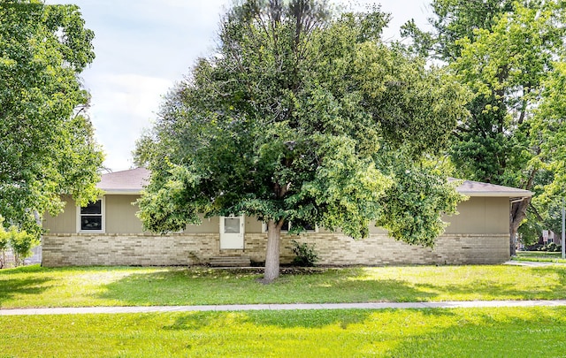 401 NE Harvey St, Grimes, IA 50111 - obstructed view of property featuring brick siding, entry steps, a front lawn, and roof with shingles