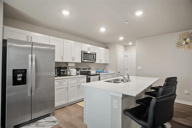 4410 NE Mongoose Ln, Ankeny, IA 50021 - kitchen with stainless steel appliances, white cabinets, light wood-style floors, and recessed lighting