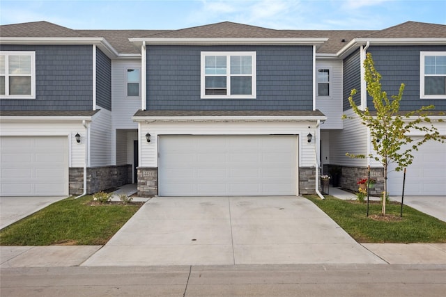 4410 NE Mongoose Ln, Ankeny, IA 50021 - view of property featuring stone siding, a garage, and concrete driveway