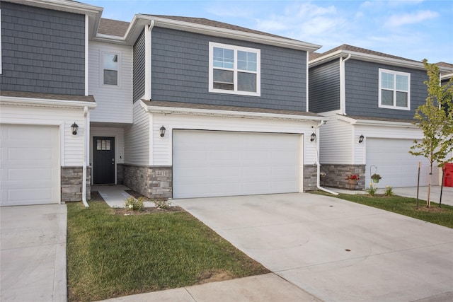 4410 NE Mongoose Ln, Ankeny, IA 50021 - view of property with stone siding, driveway, and an attached garage